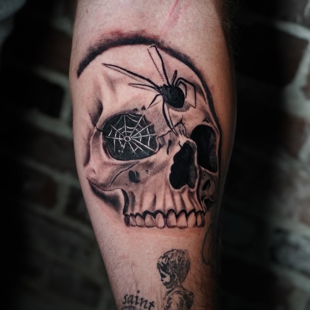 Close-up detail of skull and spider tattoo by Jesus Bernal at Broadway Dept. Sacramento