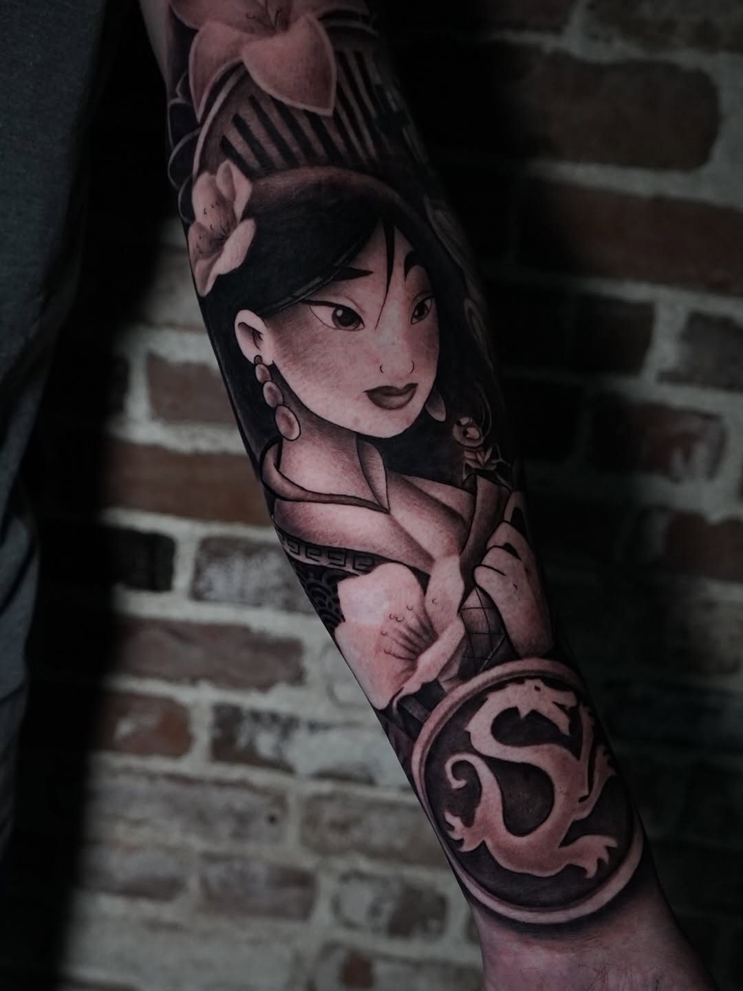 Mulan princess tattoo featuring delicate floral artwork on skin by Charleigh Rae at Broadway Dept.