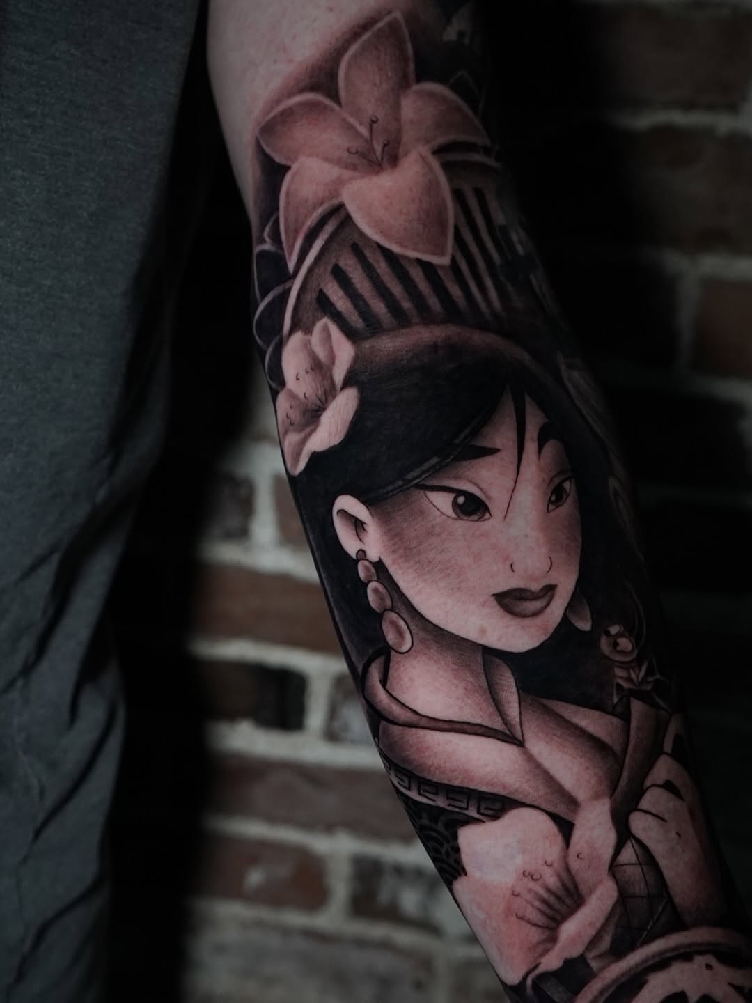 Detailed view of Mulan Disney princess tattoo with ornate floral accents by Charleigh Rae
