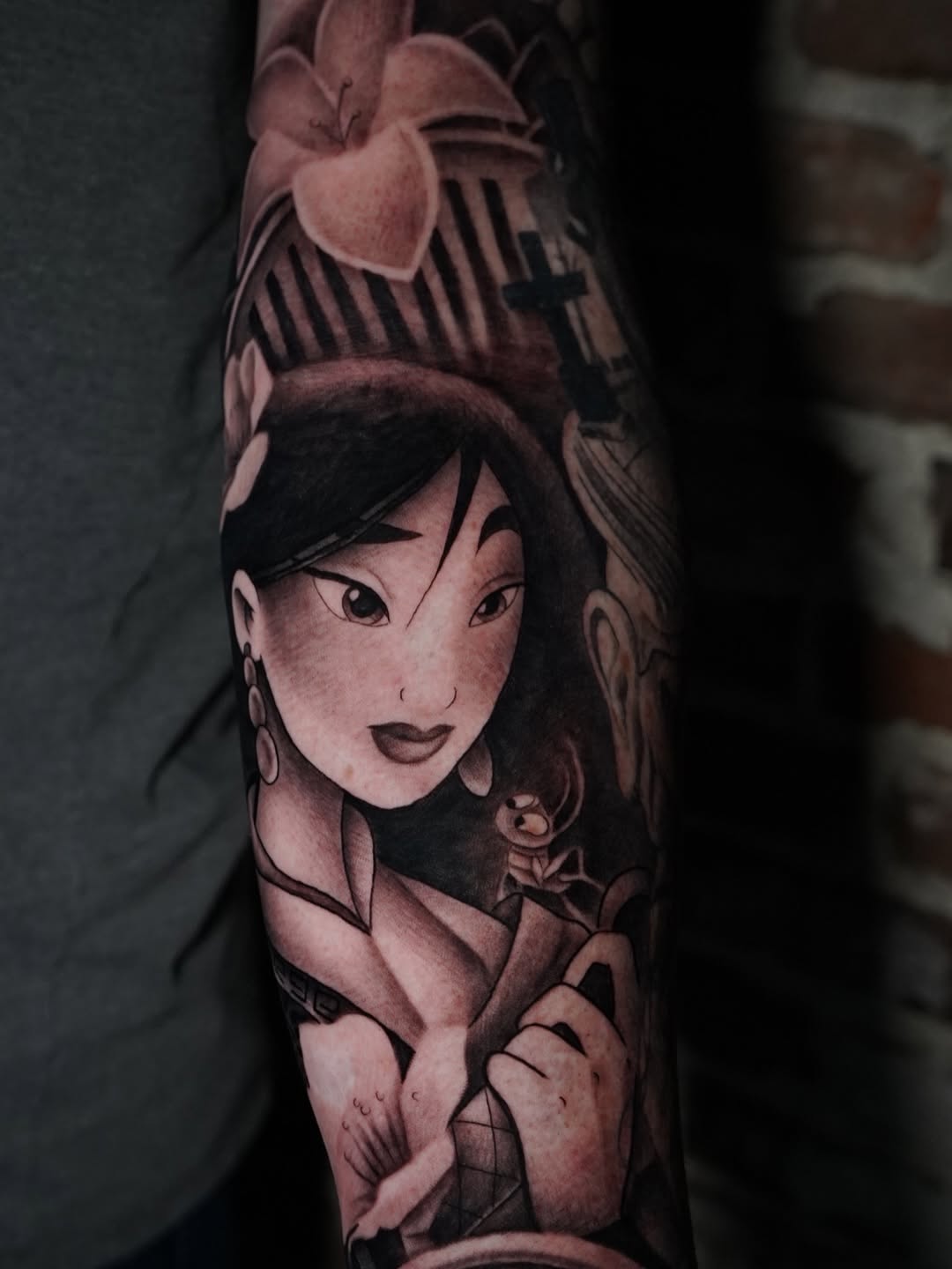 Disney Mulan tattoo design showcasing character portrait with blooming flowers by Charleigh Rae