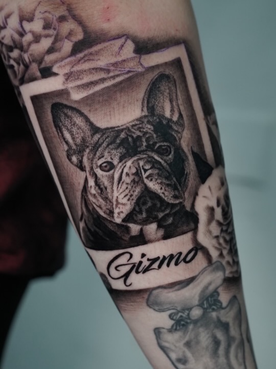 Close-up of detailed dog portrait tattoo showing realistic fur and facial features by Charleigh Rae