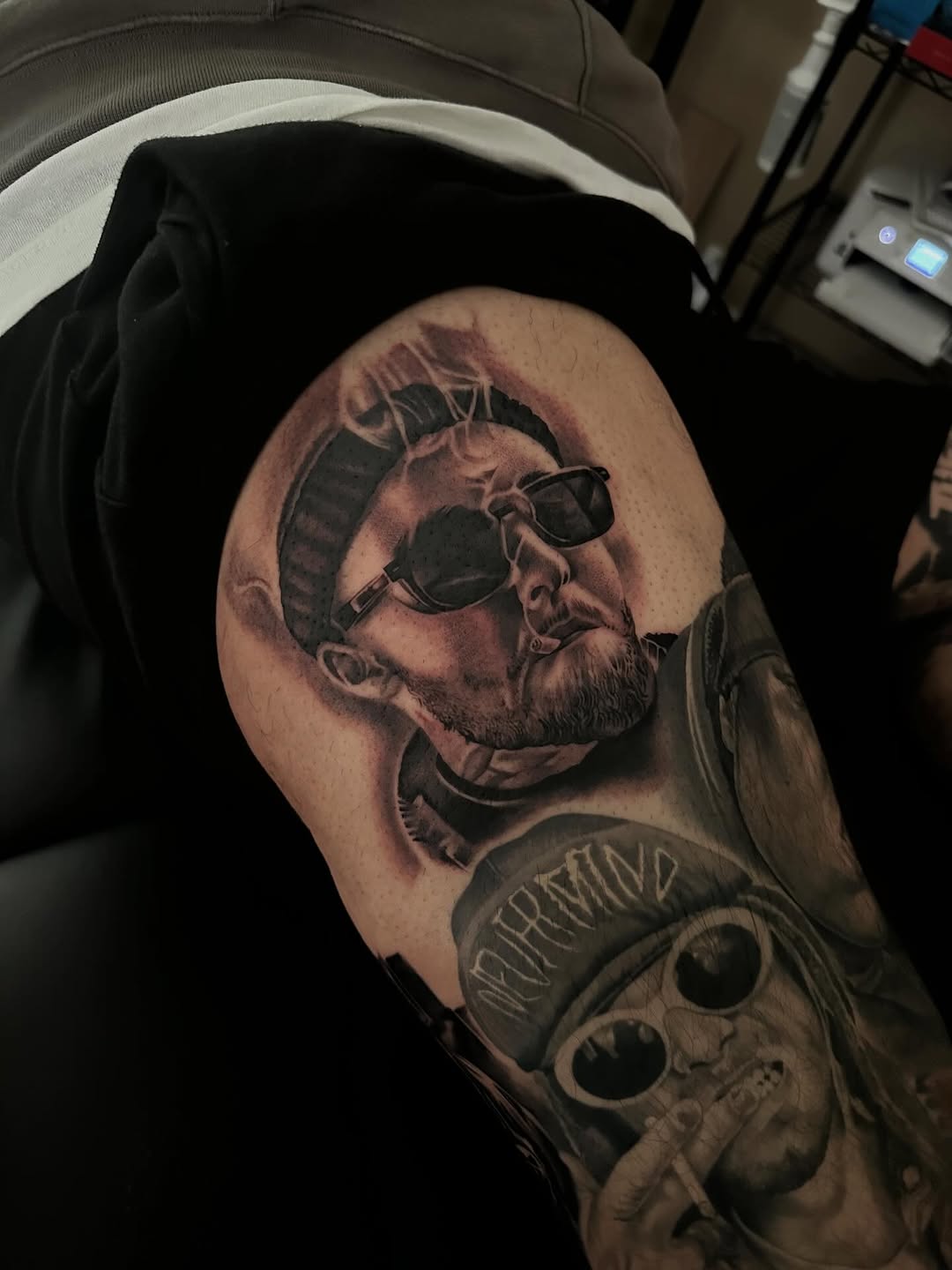 Close-up detail of Mac Miller portrait tattoo on leg by Mauricio Contreras at Broadway Dept. Sacramento