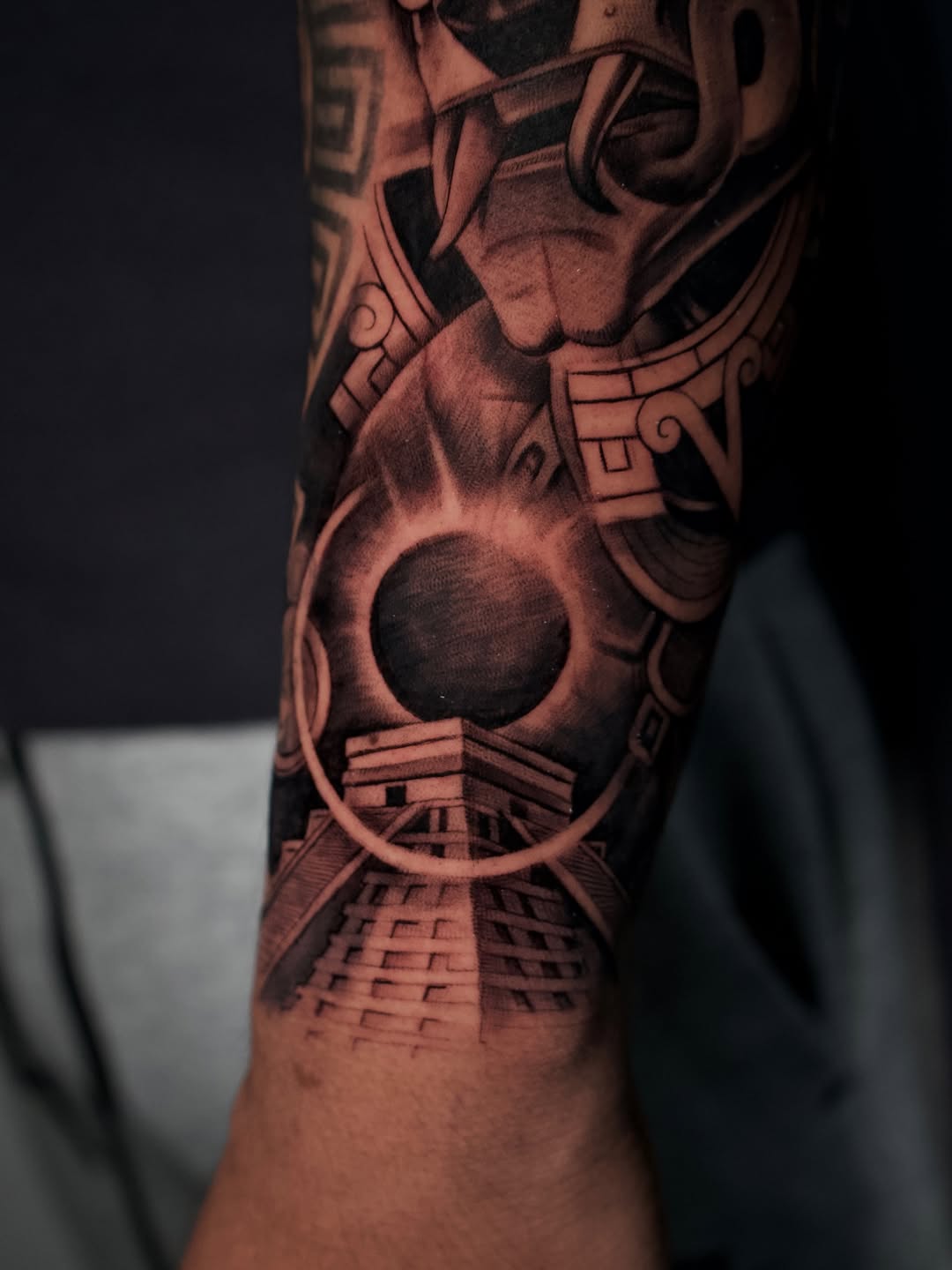 Healed inner forearm tattoo complementing outer forearm Aztec design