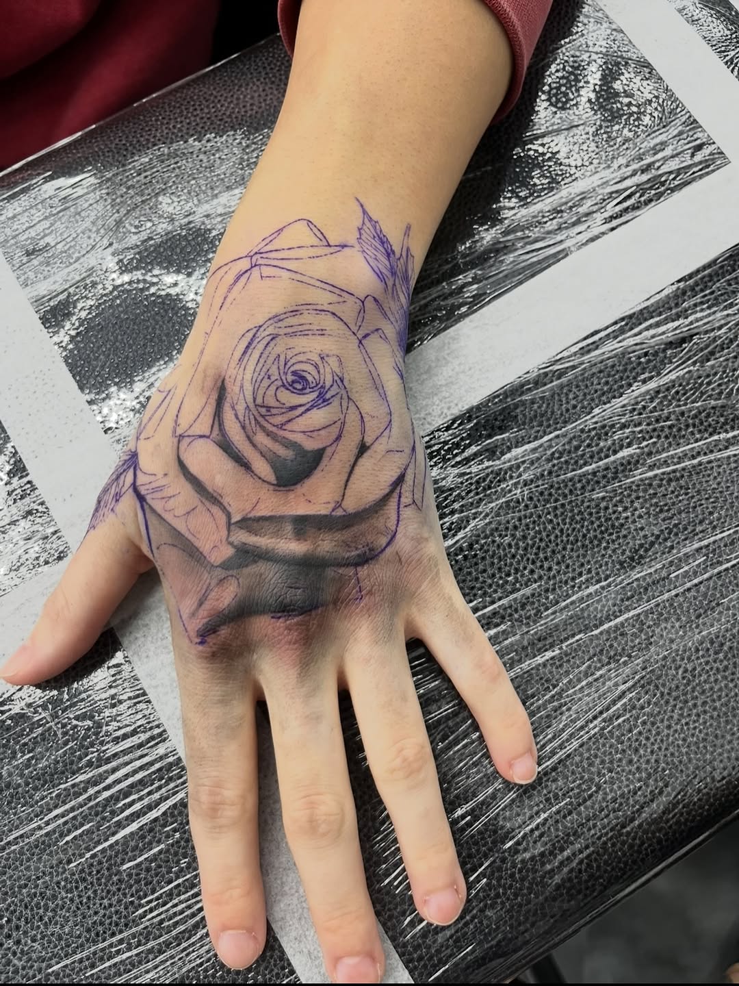 Close-up view of rose tattoo design by Jesus Bernal at Broadway Dept. Sacramento