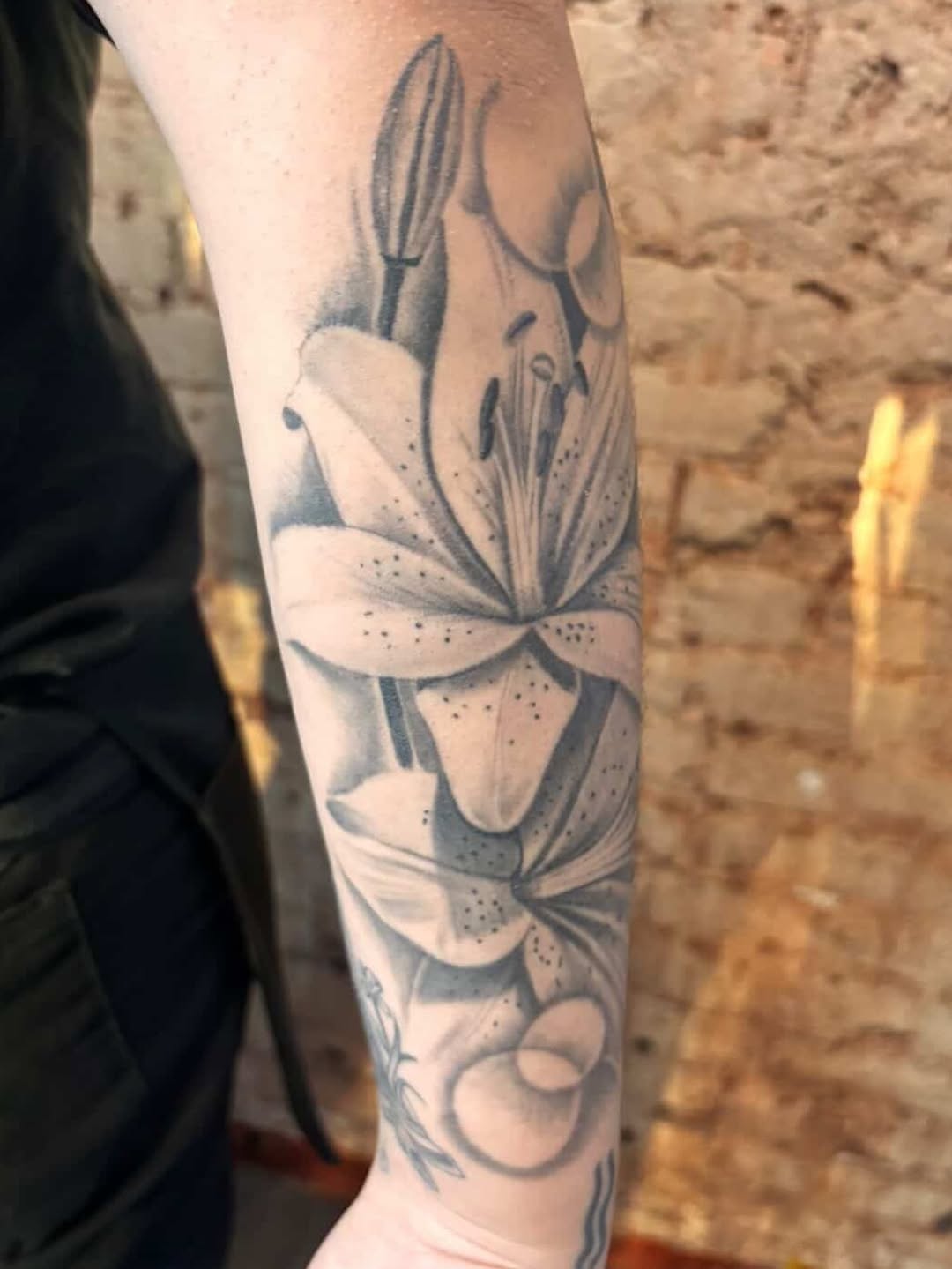 Close-up of lily tattoo work by Jesus Bernal at Broadway Dept. Sacramento