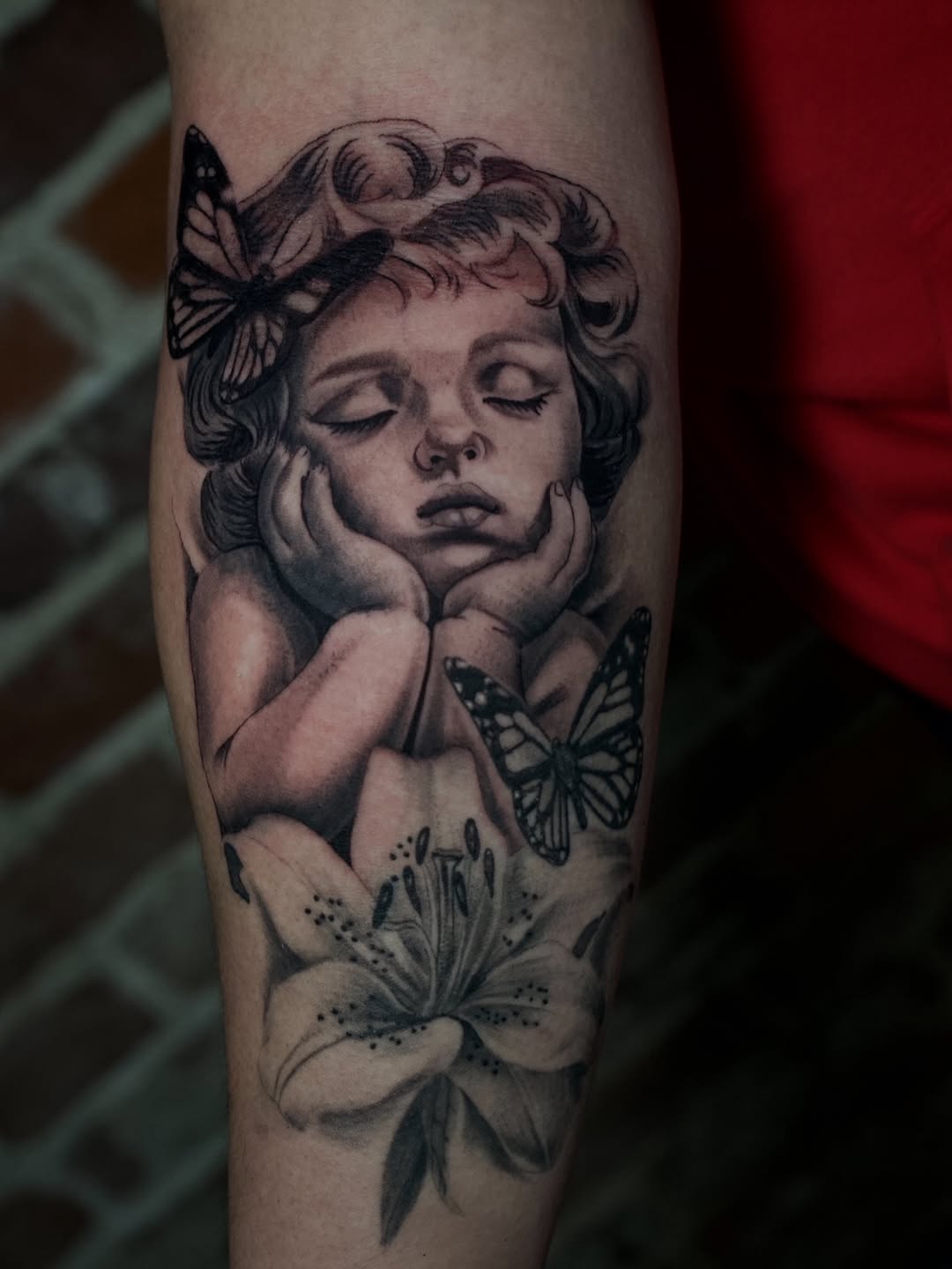 Baby Cherub Lily Tattoo by Jesus Bernal at Broadway Dept. Midtown Sacramento