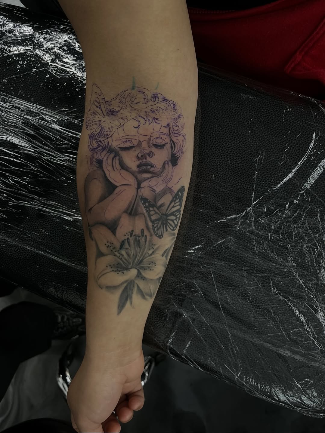 Finished baby cherub and lily tattoo piece by Jesus Bernal at Broadway Dept. Midtown Sacramento