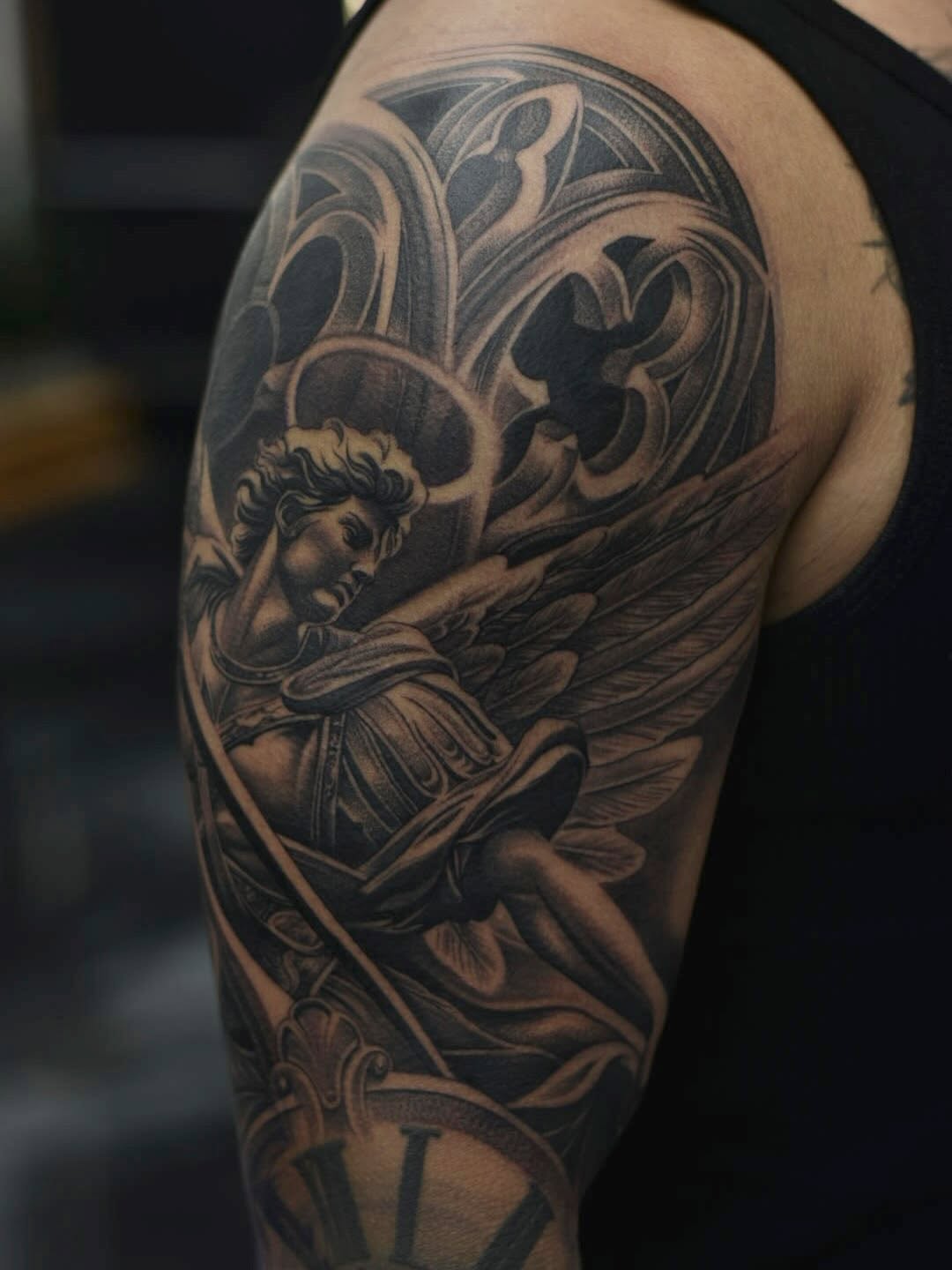 Detailed view of religious archangel tattoo with sword imagery by Mauricio Contreras