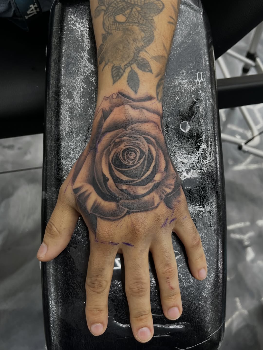 Rose tattoo on hand by Broadway Dept. on 21st Street Sacramento