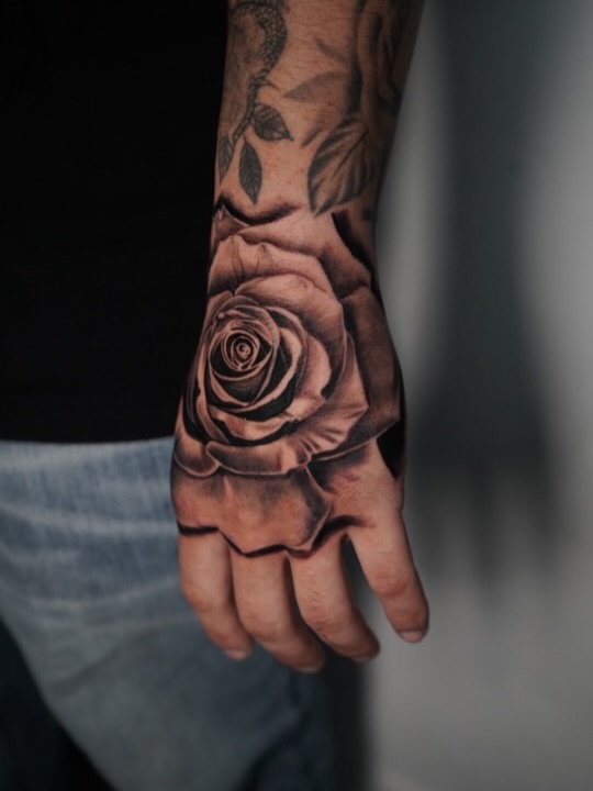 Hand blast rose tattoo at Broadway Dept. Sacramento tattoo shop