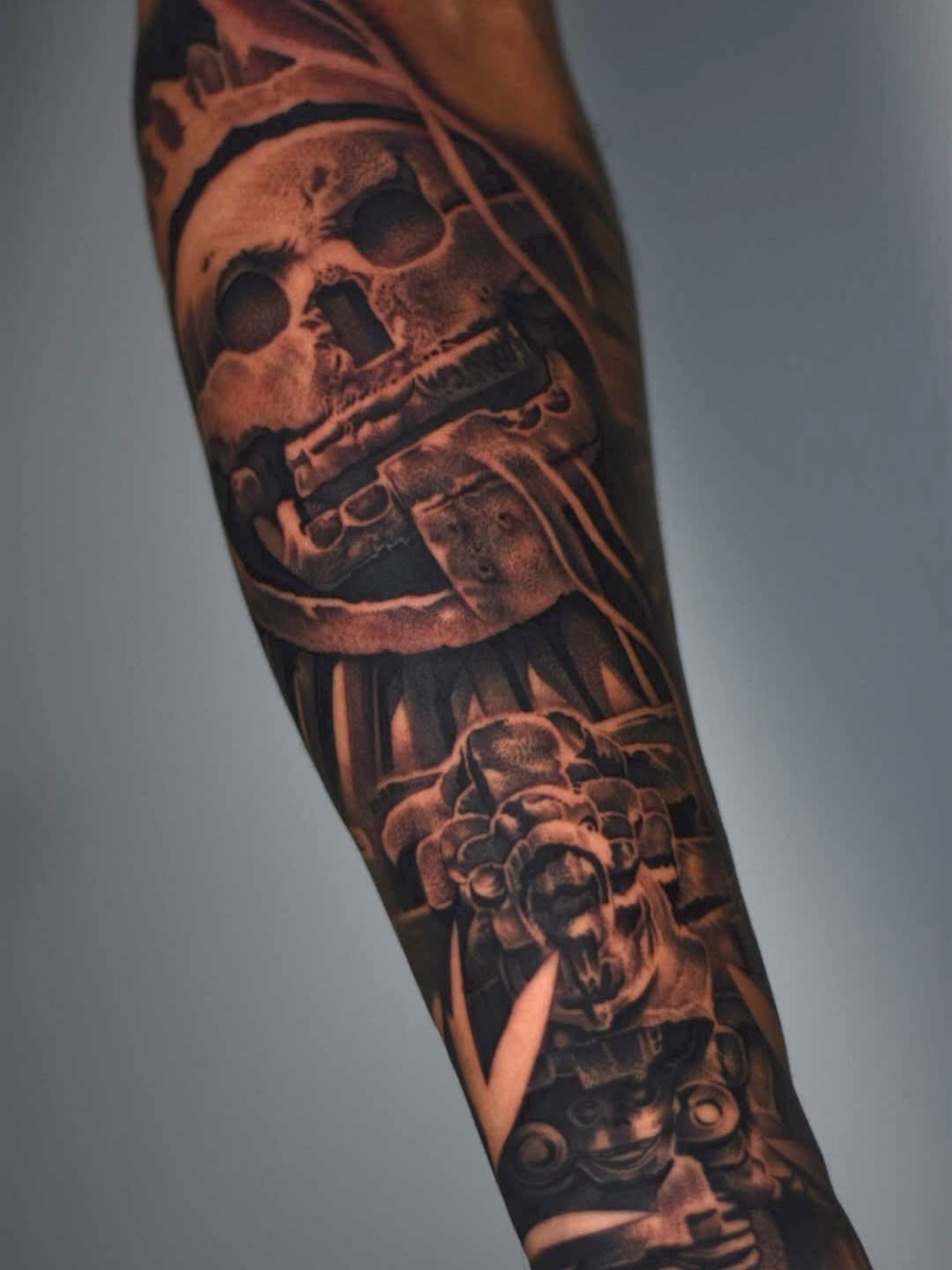 Close-up detail of Mictlantecuhtli tattoo showing intricate linework at Broadway Dept. Midtown Sacramento
