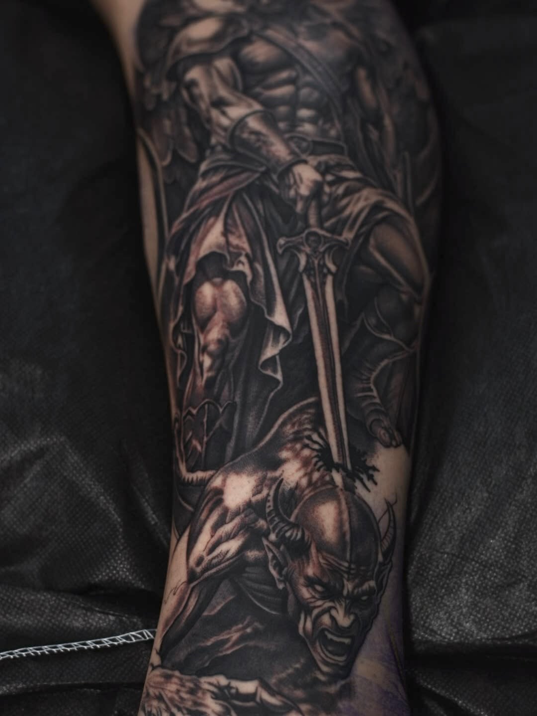 Close-up of custom tattoo design being completed by artist at Broadway Dept