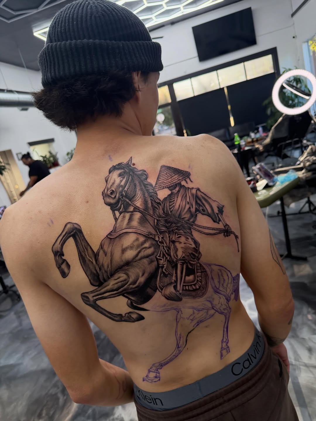 Tattoo artist working on client during back-to-back session at Broadway Dept. Sacramento