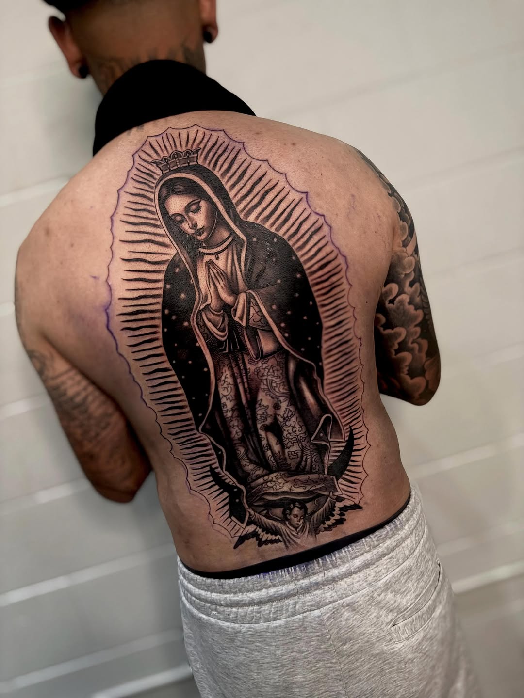 Detailed Virgin Mary back piece tattoo by Bella Gomez at Broadway Dept. Sacramento