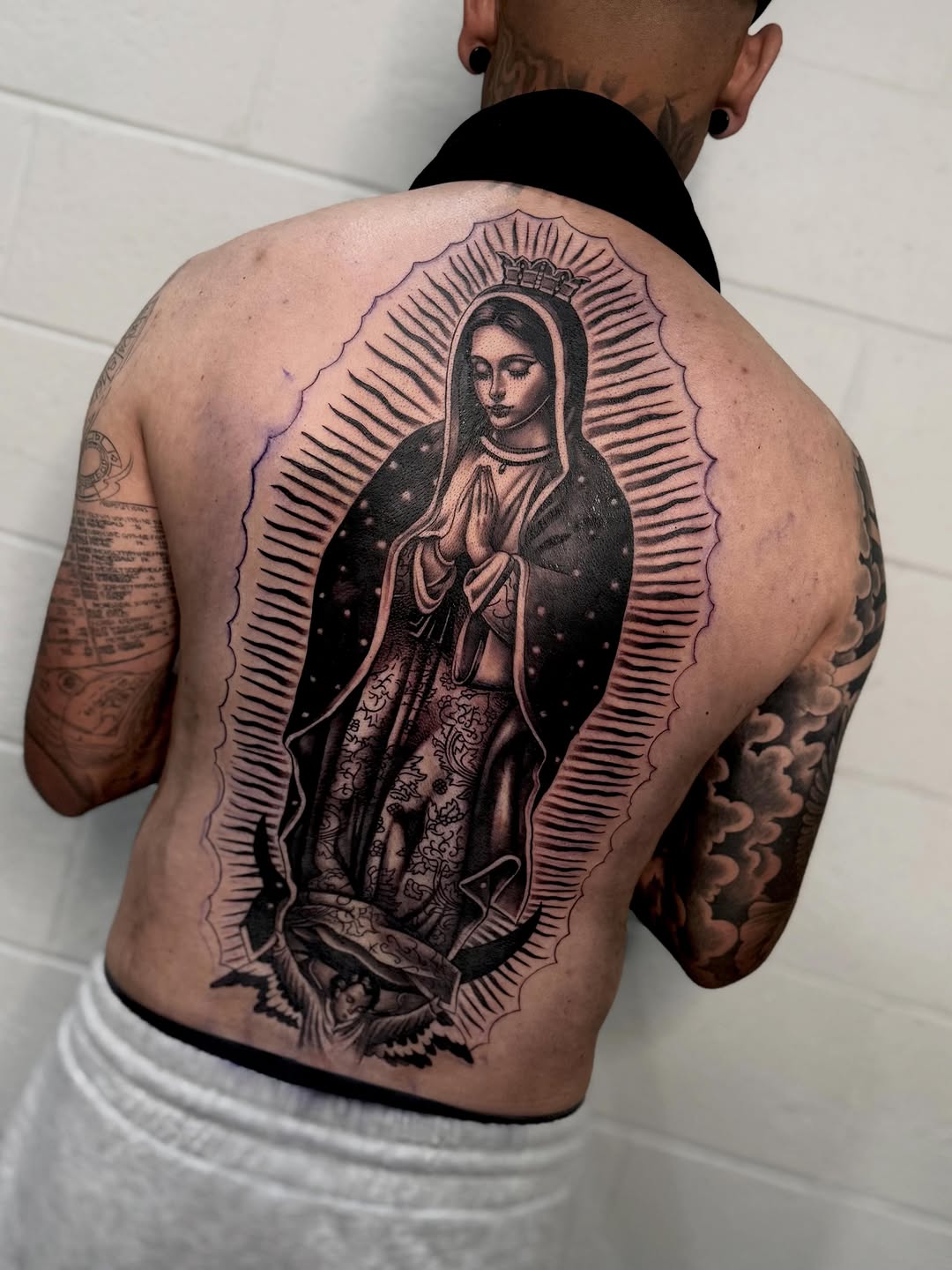 Completed Virgin Mary back tattoo by Bella Gomez at Broadway Dept. Sacramento