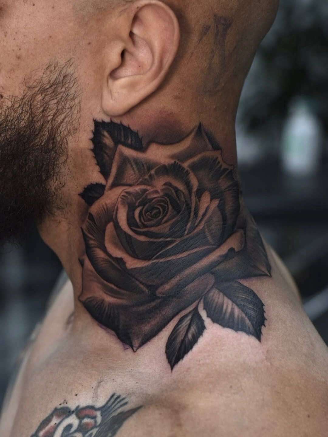 Traditional rose tattoo featuring bold lines and classic styling at Broadway Dept. Sacramento.