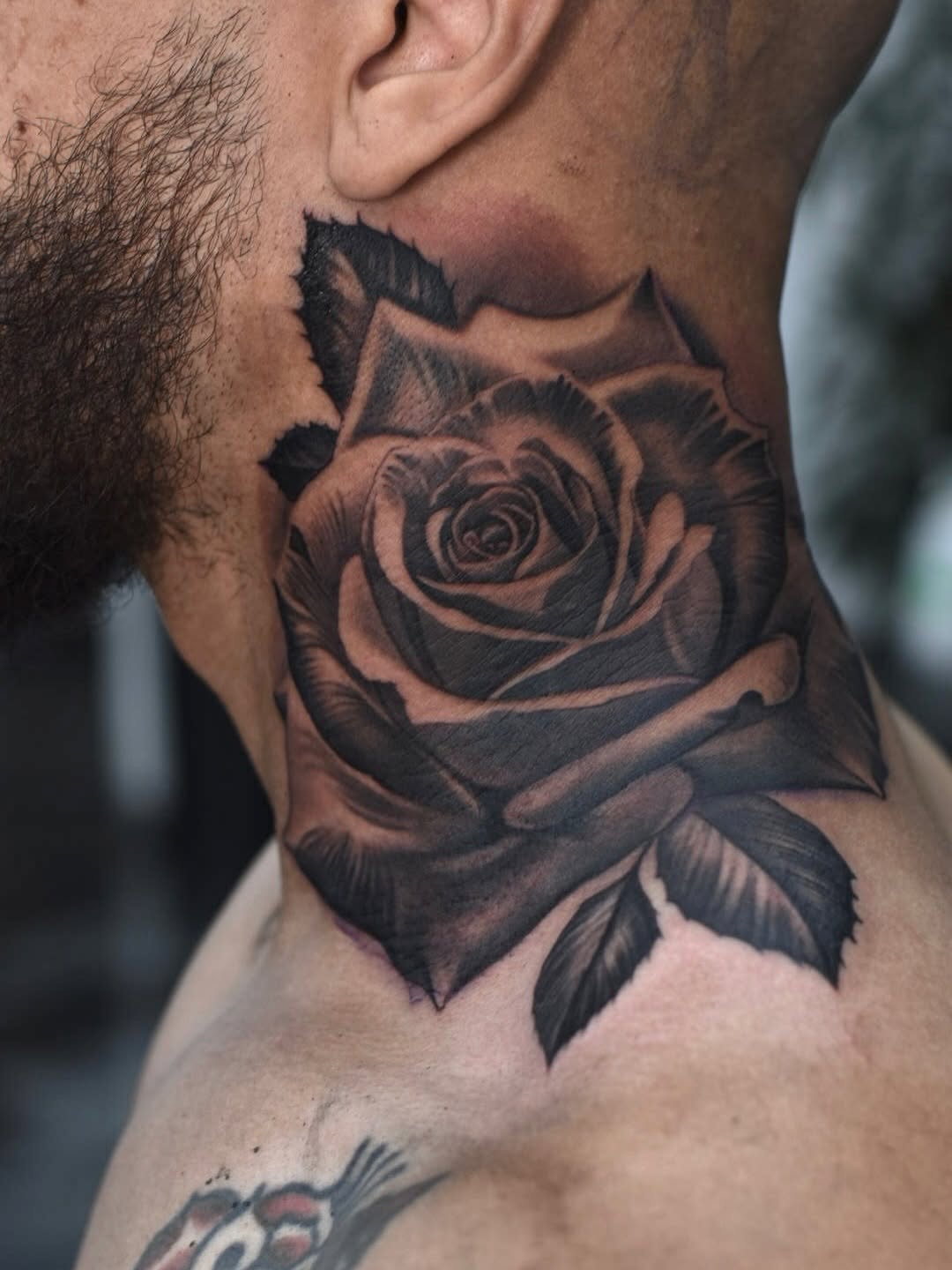 Detailed rose tattoo with elegant petal work and stem detail by Broadway Dept. Midtown Sacramento.