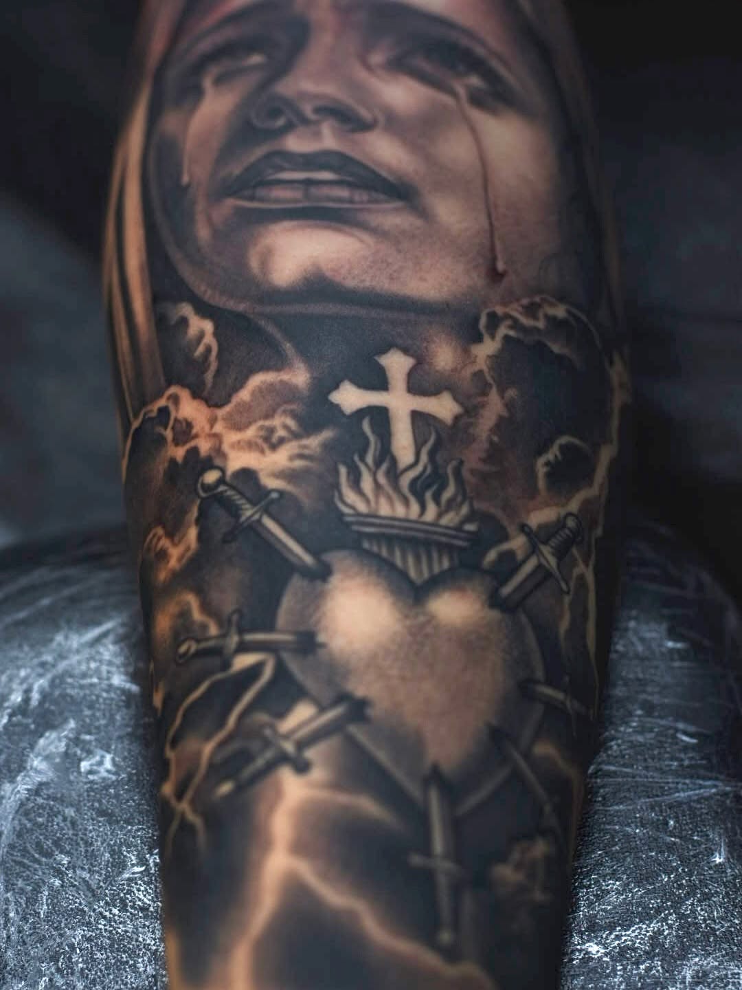 Close-up detail of religious sleeve tattoo artwork at Broadway Dept. Midtown Sacramento