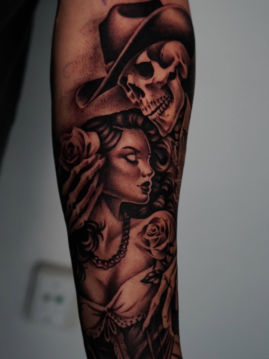 Rose and black tattoo design on client at Broadway Dept. Sacramento