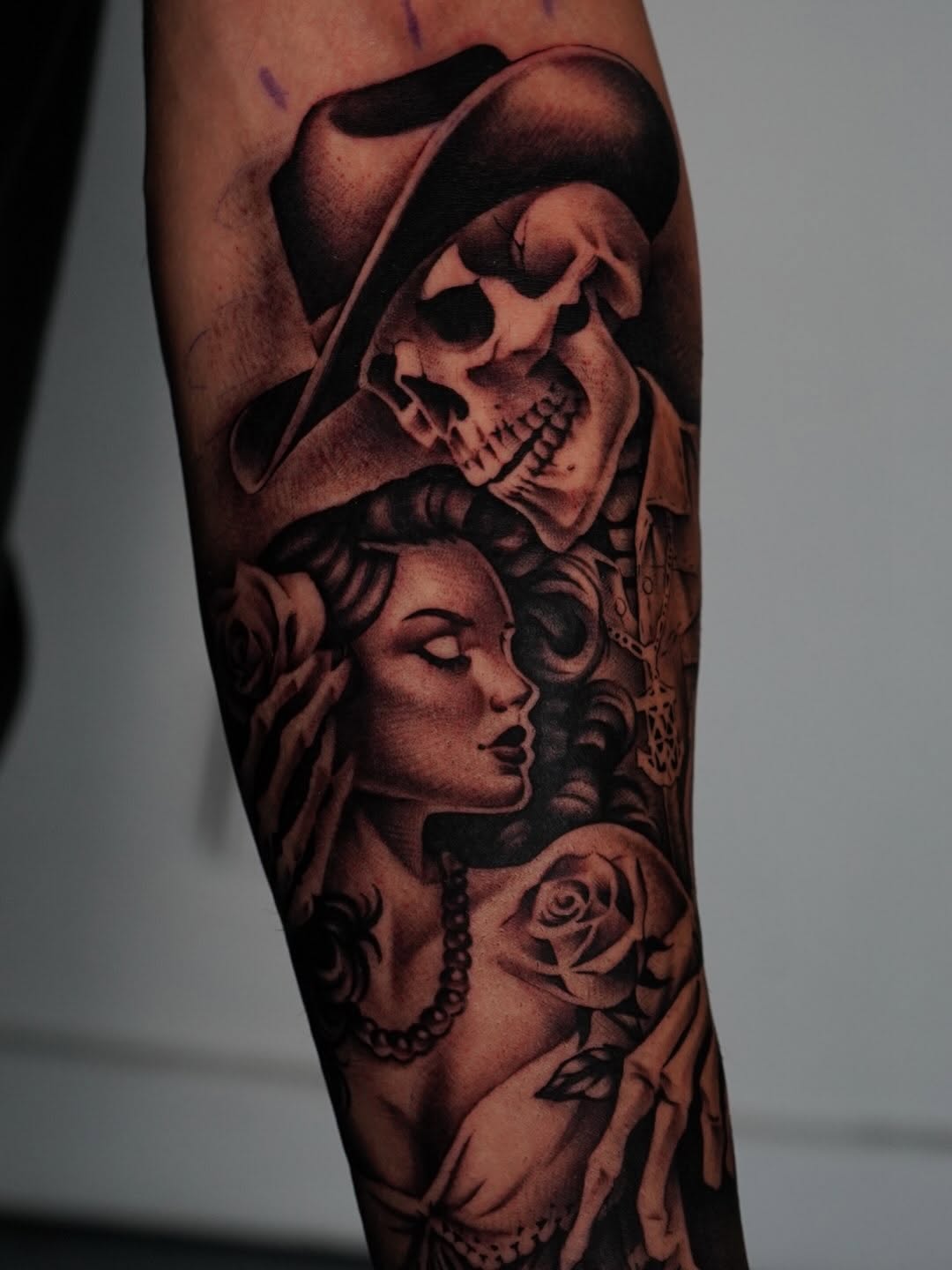 Completed rose and black tattoo on client skin at Broadway Dept.