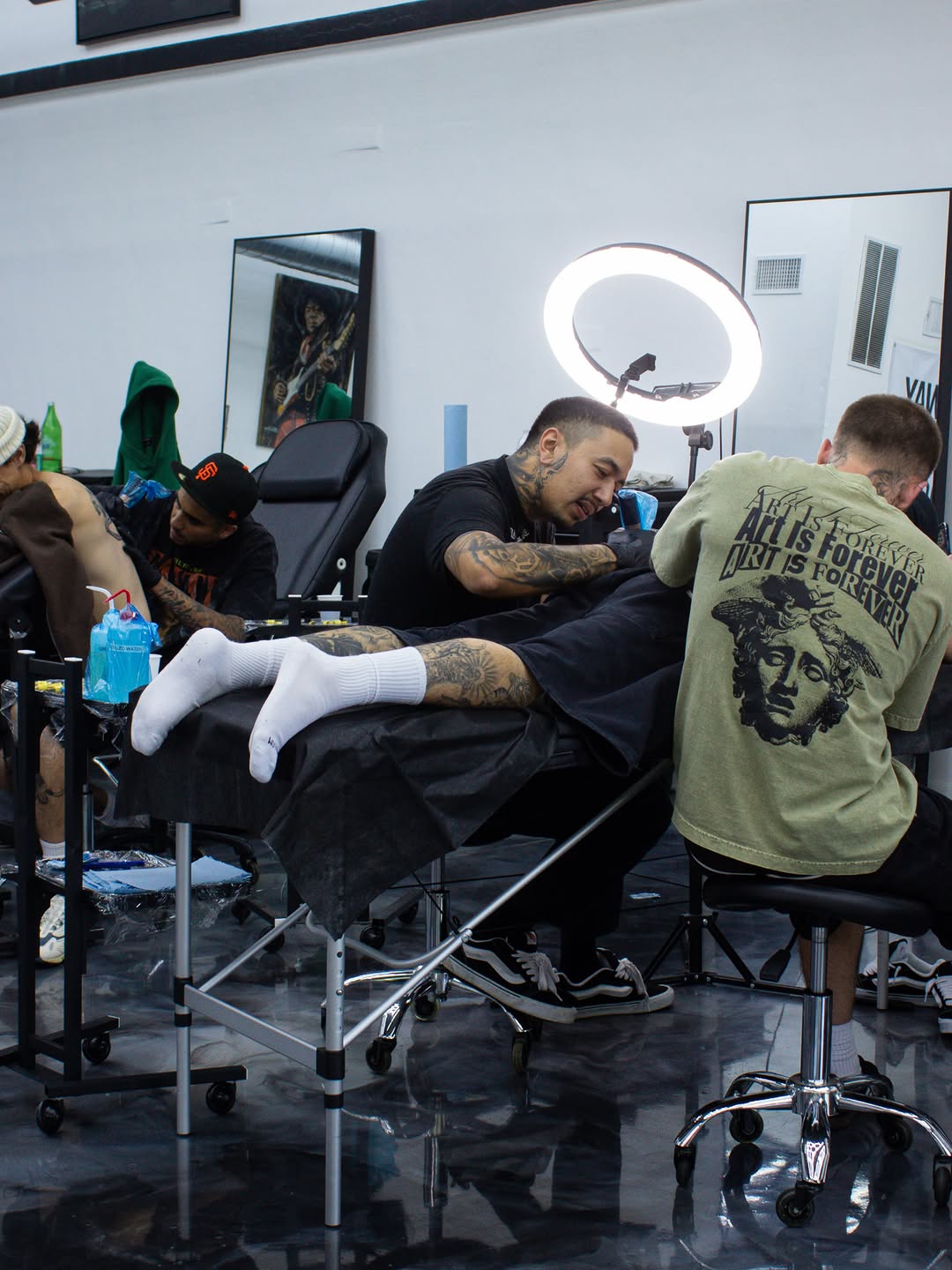 David Maciel tattooing back piece at Broadway Dept while collaborating with fellow artists
