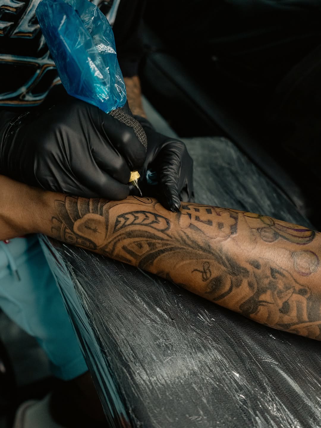 Artist applying freehand gap filler tattoo at Broadway Dept Sacramento