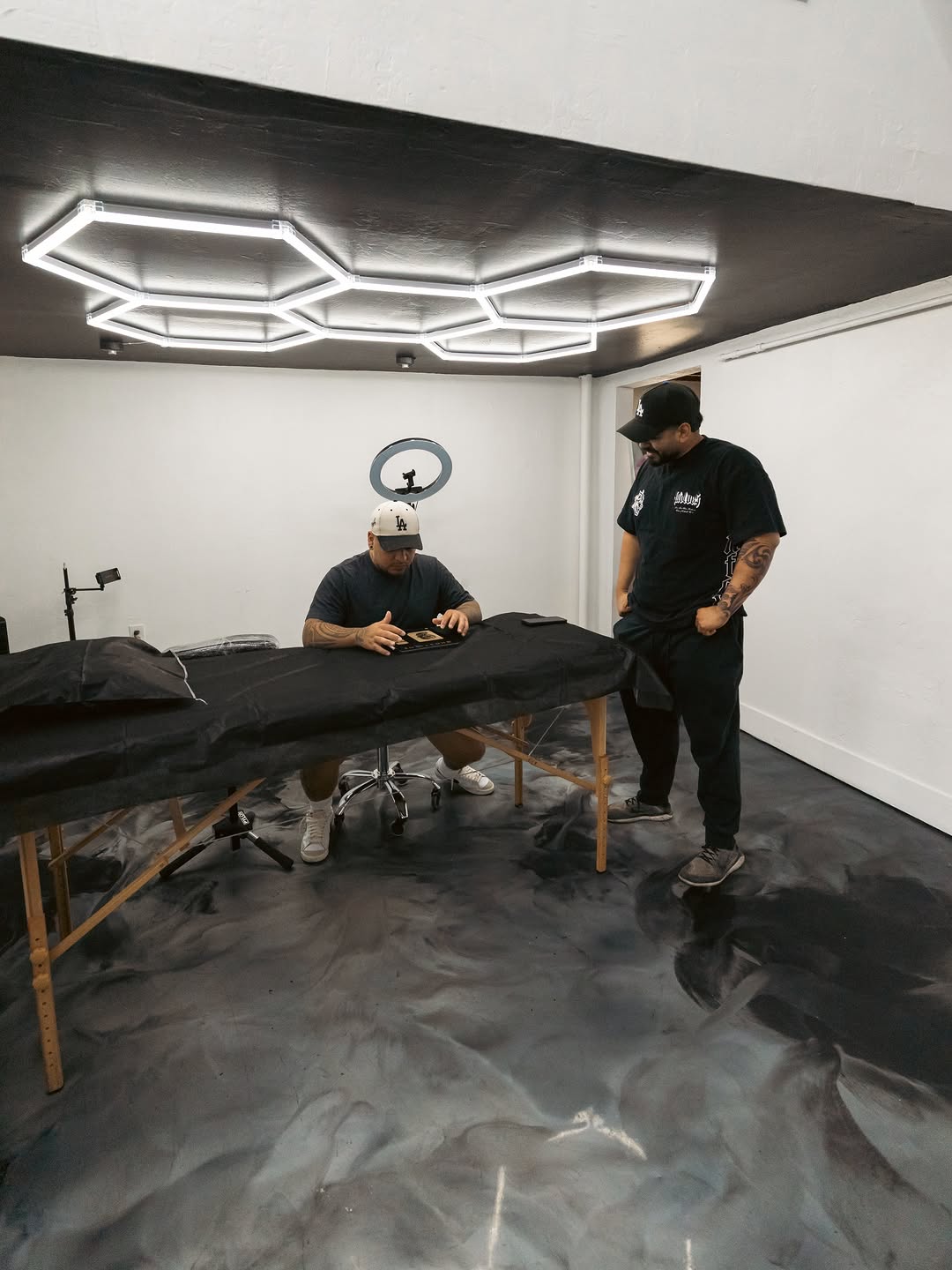 Tattoo artist working on a client at Broadway Dept located on 21st Street in Sacramento