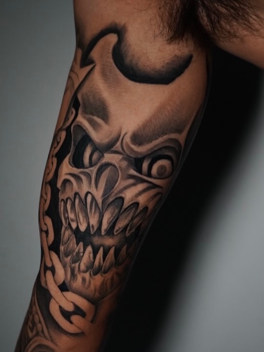 Close-up detail of healed mask tattoo design by Jesus Bernal at Broadway Dept. Sacramento