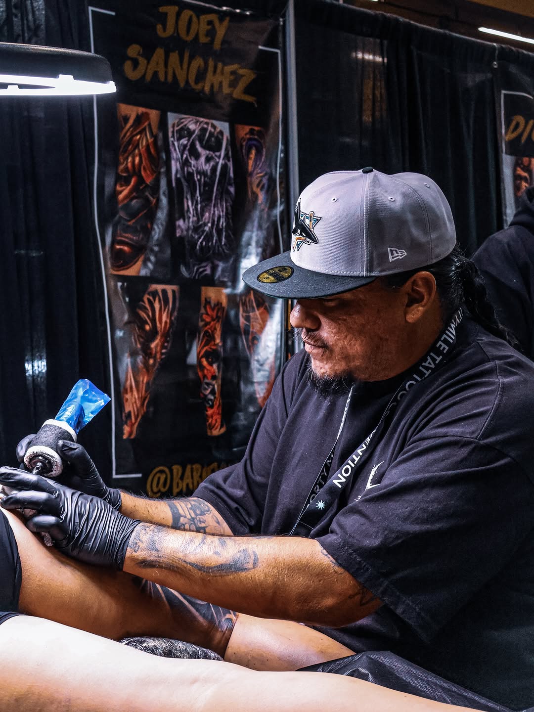Tattoo artist demonstrating technique at Forty Mile Tattoo Convention.