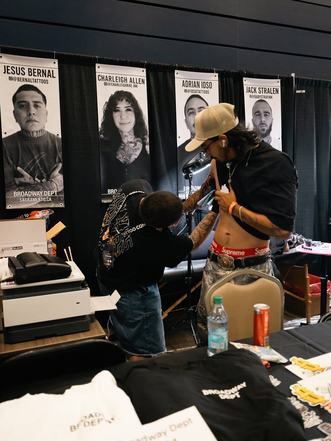 Tattoo artists and staff showcasing work at Forty Mile Tattoo Convention
