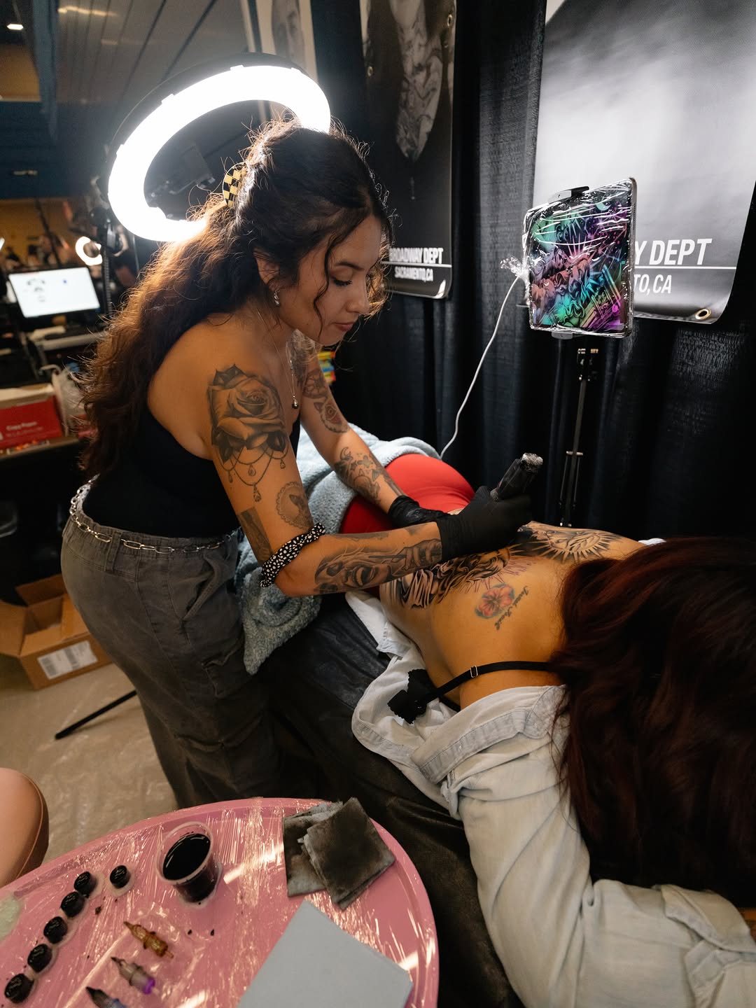 Tattoo artist demonstrating technique at Forty Mile Convention