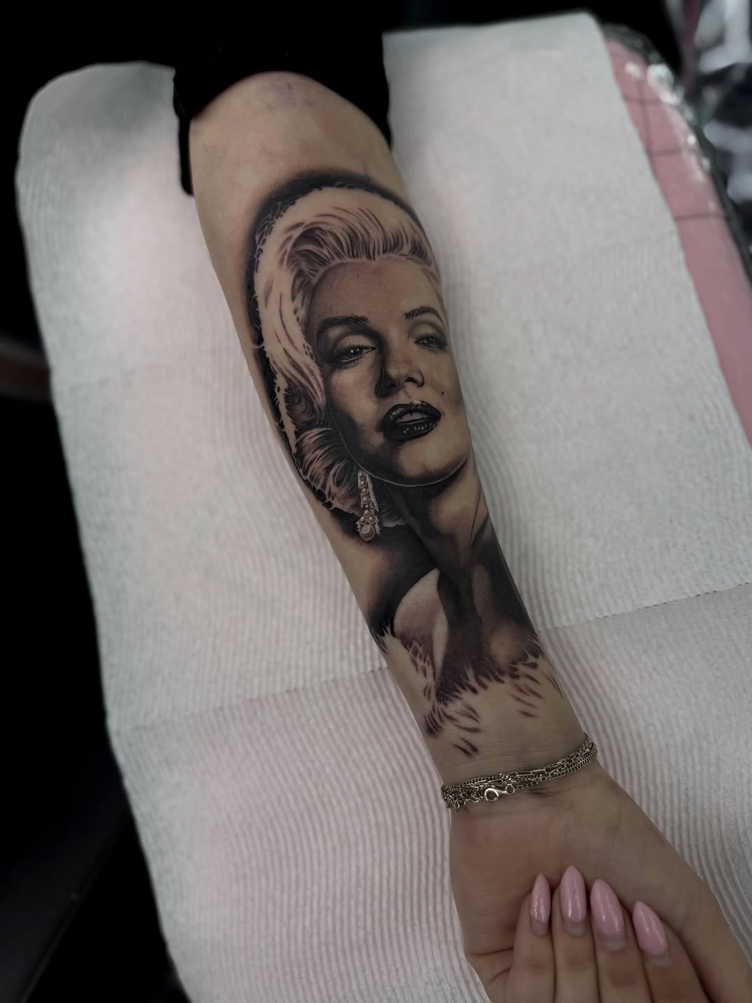 Close-up detail of Marilyn Monroe portrait tattoo showing black and gray work by Bella Gomez
